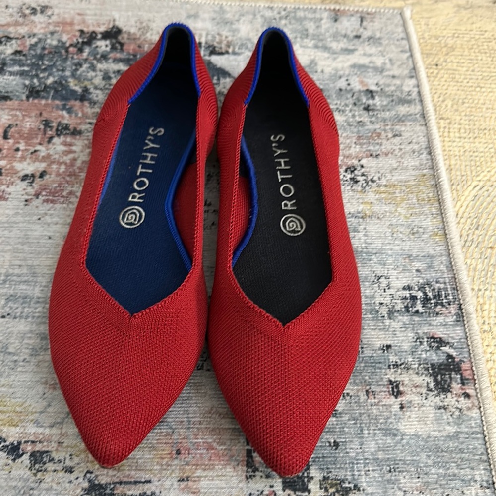 Like new size 9.5 Rothy’s the point Red flats with blue heel stitching.